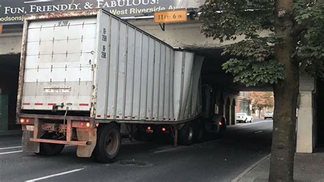 A truck gets stuck under the railroad bridge at Sprague and Brown in downtown Spolane.